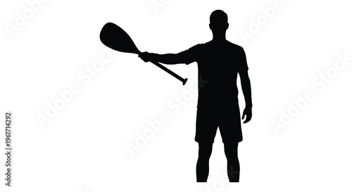 Stand up paddleboarding athlete holding a paddle in dark silhouette