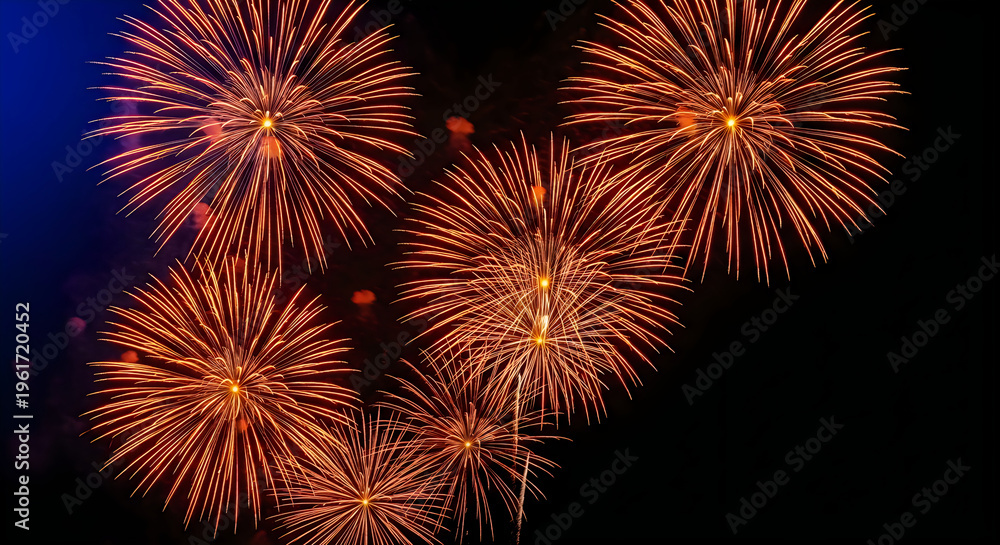 Obraz premium Brilliant orange fireworks explode against a dark deep blue night sky