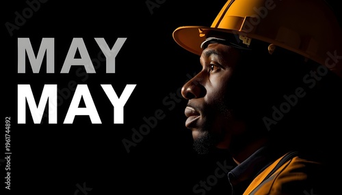 A construction worker wearing a hard hat and looking focused in a dark background with the word MAY prominently displayed