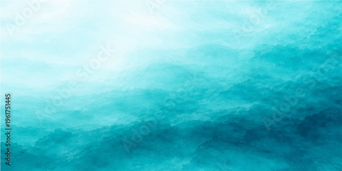 A bright blue sky with white clouds reflects on the calm summer sea at the horizon, creating a beautiful nature landscape filled with light and peaceful ocean waves