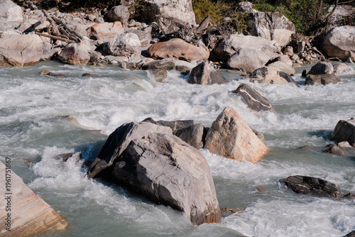 Fast Flowing Mountain River with White Foam and Boulders in High Altitude Valley