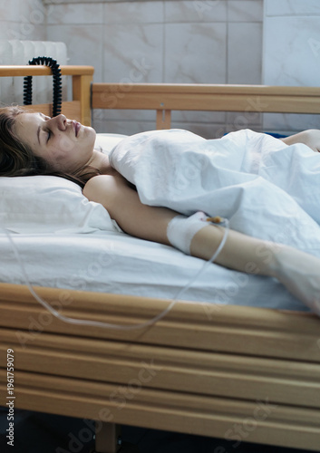 Young Woman Patient in Hospital Bed