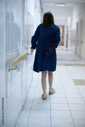 Patient Walking Down Hospital Hallway