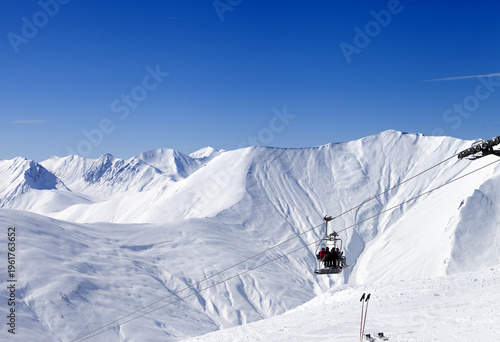 Skiers on ropeway at ski resort Gudauri