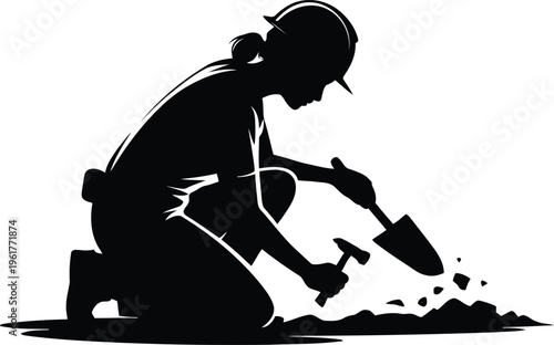 Silhouette of a female archeologist kneeling and working the earth with a shovel and hammer