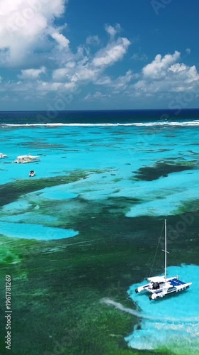 Tropical island waters with boats from a bird’s-eye view, shallow water