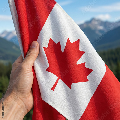 A hand holding a Canadian flag with a beautiful maple leaf vector symbol at the center copy