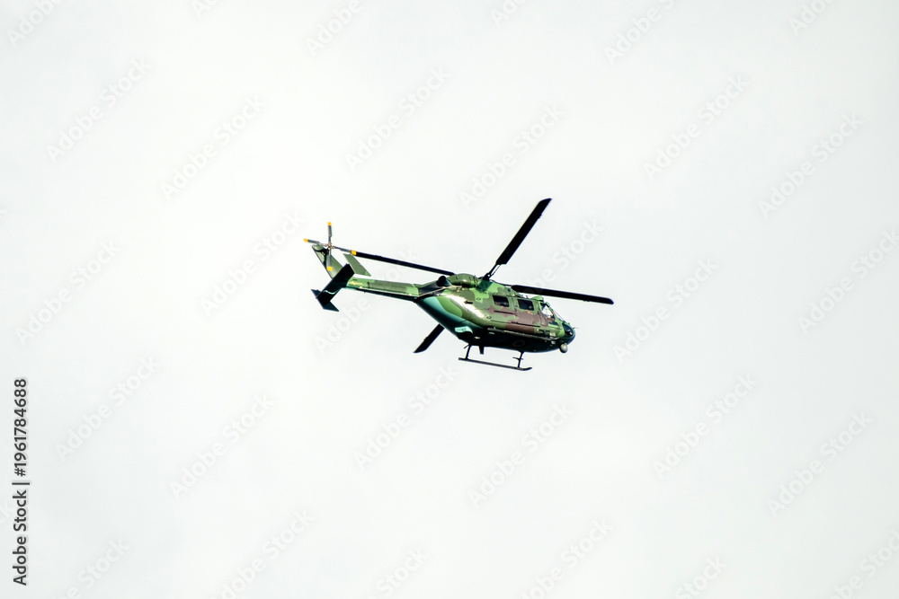 Fototapeta premium Helicopter formation against isolated cloudy mid sky