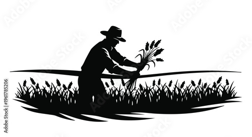 Farmer harvesting wheat in a golden field at sunset, silhouette against the sky.