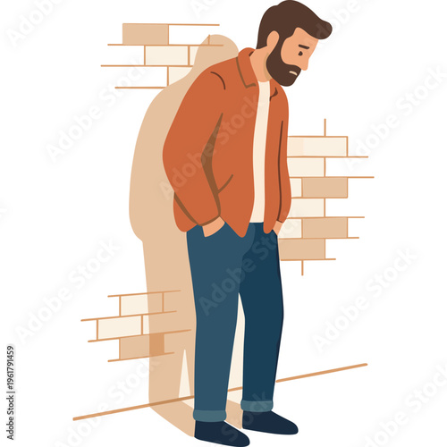 A man stands against a brick wall with his hands in pockets looking down.