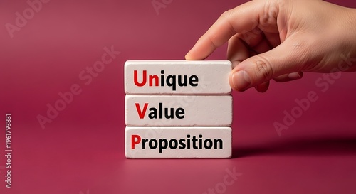 A hand holding blocks with the words unique value proposition