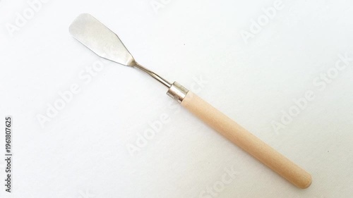 Stainless Steel Palette Knife with Wooden Handle rotating on White Background, Artist Painting Tool for Acrylic and Oil Painting