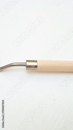 Stainless Steel Palette Knife with Wooden Handle moving on White Background, Artist Painting Tool for Acrylic and Oil Painting, vertical clip