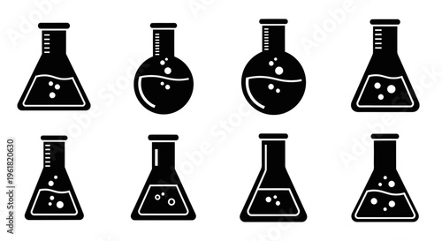 A collection of laboratory equipment including flasks and beakers on a table.