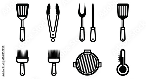 Grilling utensils and tools arranged on surface for cooking outdoors