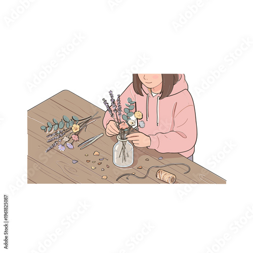 Woman arranging flowers in a vase on a wooden table indoors