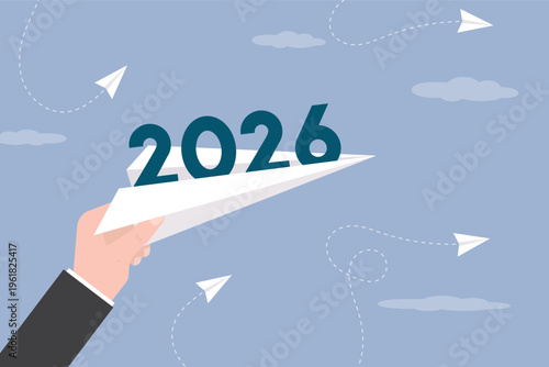 Paper plane with 2026 text inside. New opportunities, goals and expectations. Starting new year. Business theme, flight and travelling. Businessman hand launch paper plane.