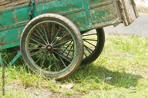 Rusty Green Cart Wheel in Grass Close-Up