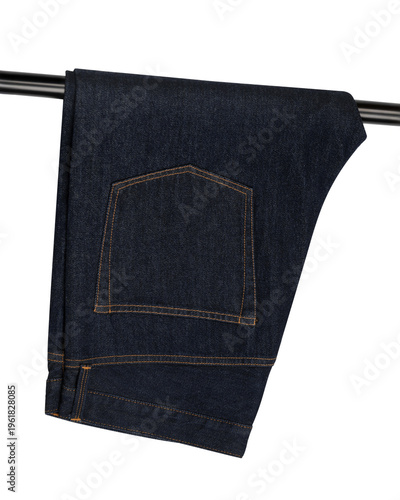 raw denim jeans folded on black pipe isolated on white
