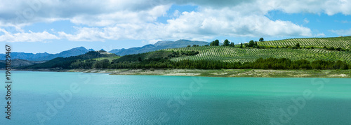 Los Bermejales Reservoir is a tranquil body of water surrounded by scenic natural landscapes and pine forests in the province of Granada, Spain