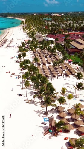 Aerial view of tropical beach, luxury resort with white sand on bright sunny day
