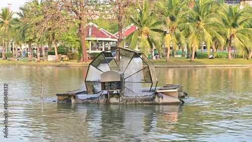 4K Paddle wheel aerator rotating in park pond
