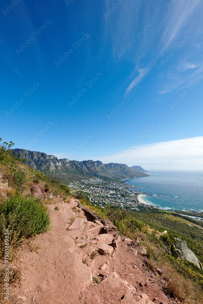 Fototapeta premium Travel, blue sky and path with mountain in nature for environment, holiday destination and sustainability. Freedom, eco friendly and ecology with outdoor trail for conservation park and adventure