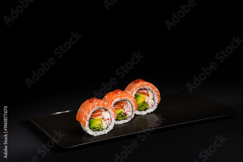 Delicious Fresh Salmon Sushi Rolls Presenting Exquisitely on a Black Background