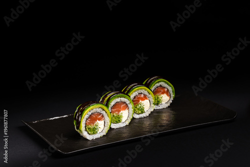 Delicious Fresh Salmon Sushi Rolls Presenting Exquisitely on a Black Background