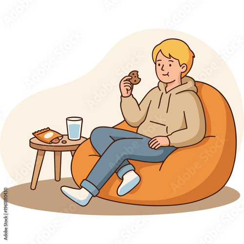 A young man relaxes on a beanbag chair eating chocolate with snacks nearby.