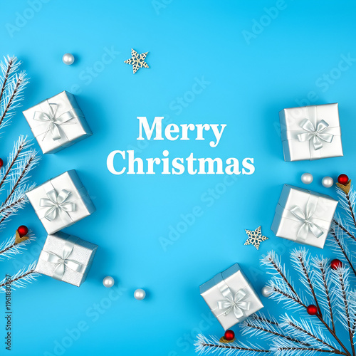 Christmas silver handmade gift boxes on blue background top view. Merry Christmas greeting card, frame. Winter xmas holiday theme. Happy New Year. Flat lay