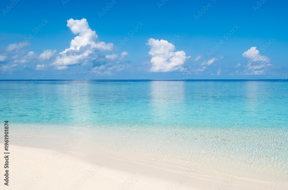 Fototapeta premium Calm tropical sea landscape with beautiful white beach sand and turquoise sea water reflecting clouds