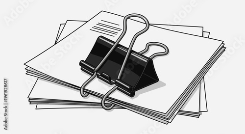 Black binder clip holding papers.