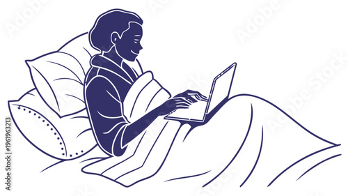 Person working on laptop in bed at night with blanket and pillows comfortable remote work setup