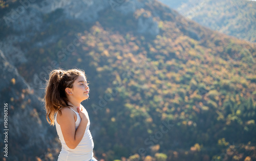 Toddler girl breathing fresh mountain air 