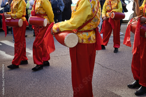 Roma, 2/22/2026 .Joyful Chinese New Year Parade Drummers in Traditional Yellow and Red Costumes Celebrating in Street