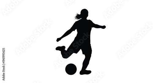 Female soccer player in action kicking a ball a dark silhouette