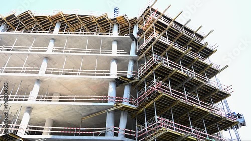 Reinforced concrete structure under construction with scaffolding