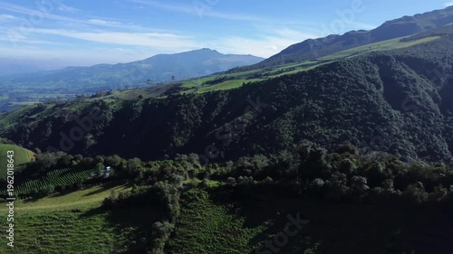 Drone shot of mountains covered in lush forests on the foot of the Rumiñahui volcano near Machachi. Mejía Canton, Pichincha Province.