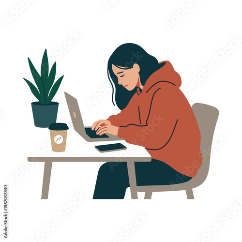 A woman sits at a desk working on her laptop surrounded by a plant and coffee