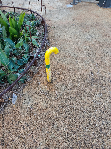 Tablou pe pânză Yellow natural gas pipeline vent pipe for cathodic protection and pressure relief installed in a public park area with gravel and plants