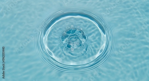 Clear blue water ripple creating perfect concentric circles on a serene liquid surface