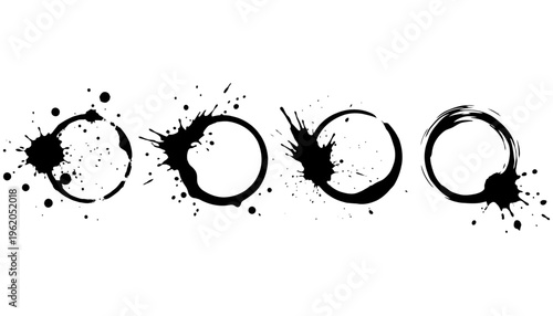 A horizontal line of four abstract black ink splatters resembling coffee cup rings and drops on a clean white surface stain liquid splash grunge dirty messy artistic creative