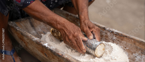 Women processing manioc roots for flour
