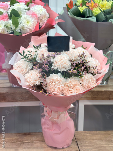 Bouquet of flowers in a vase with black label in a flower shop.