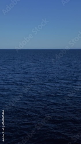 View of a vertical footage of he deep blue aegean sea from a ferry boat in slow motion