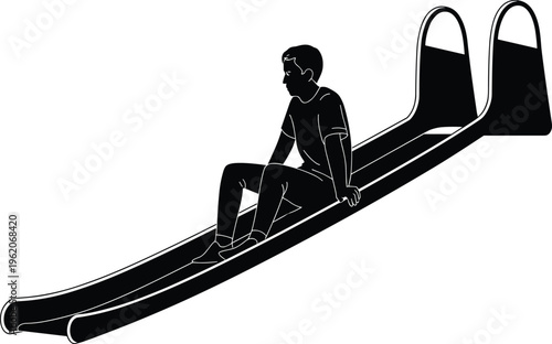 Black silhouette of a young boy sitting on a playground slide preparing to slide down during an outdoor recreational activity.