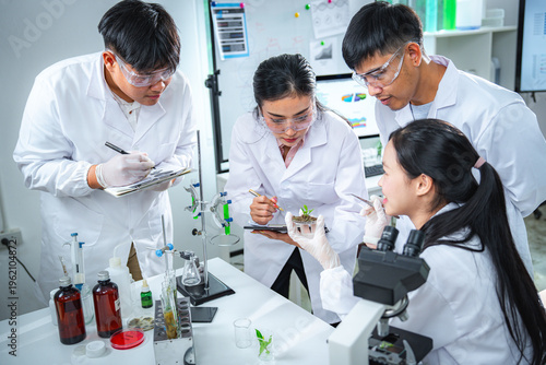 Scientists team discussing and analyzing sustainability data in a modern laboratory, making data-driven decisions for green energy solutions, climate action, and net zero innovation strategies.