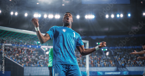 Canvastavla Black Male Soccer Striker Pumps Both Fists and Yells in Celebration Near the Goal After a Decisive Score During an International Football Championship Match Game in a Packed World Stadium