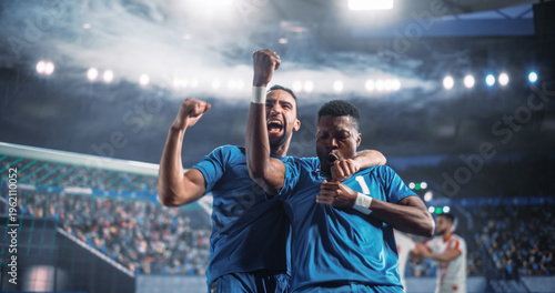 Tableau sur toile Black Male Soccer Teammates Celebrate a Crucial Goal Beside the Net During a Professional International Tournament Match, Raising Clenched Fists as Rivals Fade in the Background of a World Stadium
